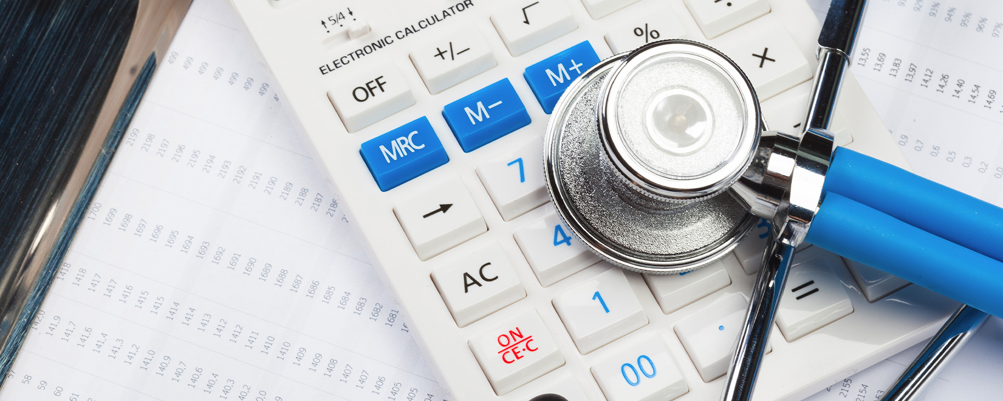 health care costs. stethoscope and calculator