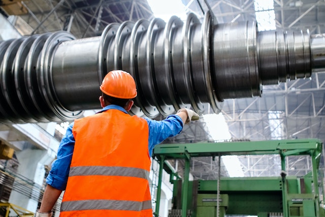 employee looking at machinery