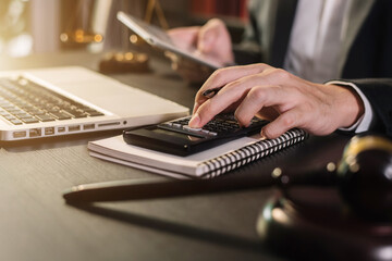 man working on calculator
