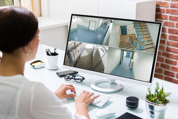 woman on computer with surveillance footage