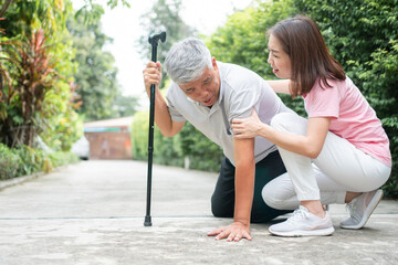 woman helping man with cane after fall