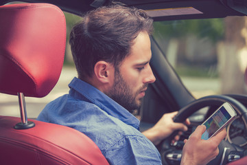 man texting while driving