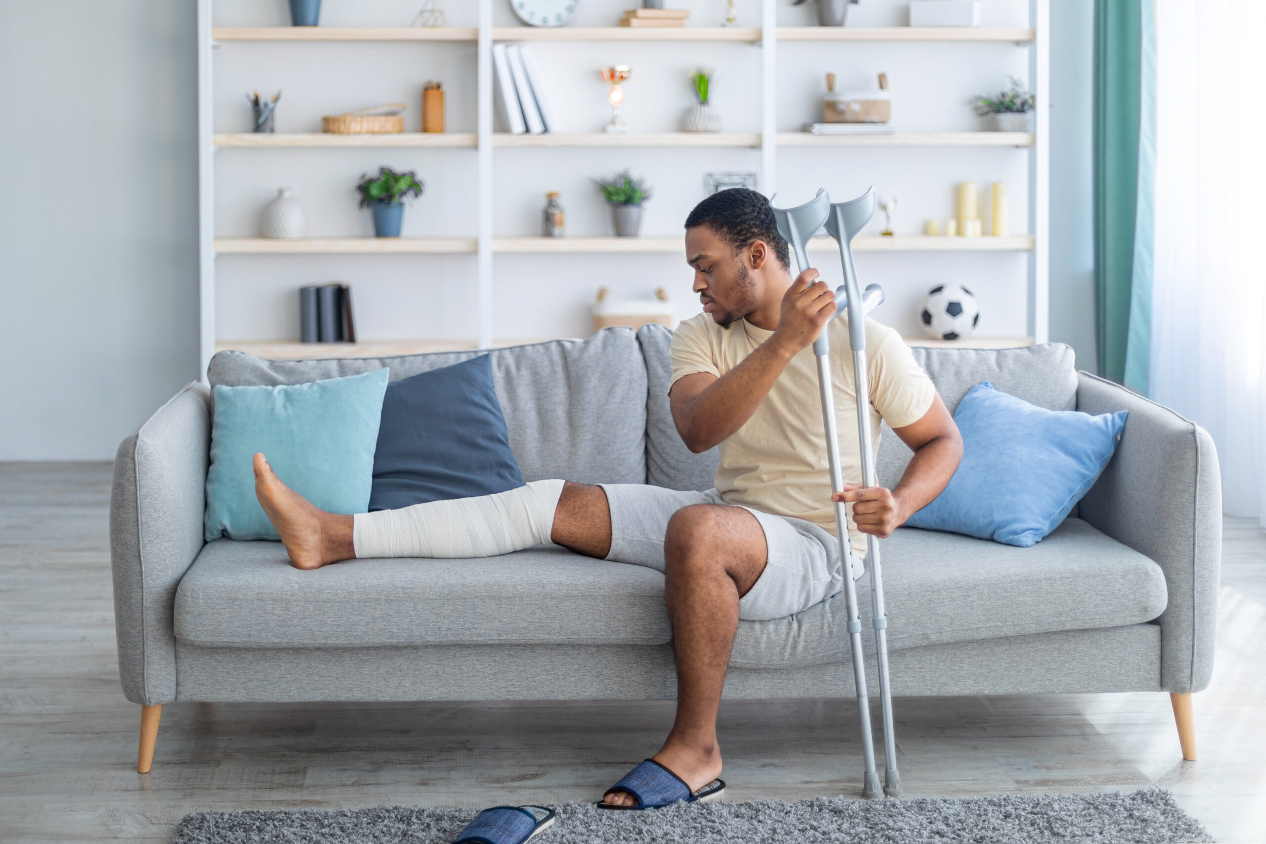man with broken leg at home